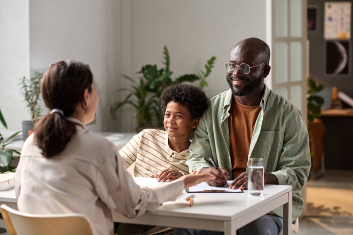 Smiling father and child consulting with lawyer - lake charles child custody attorney